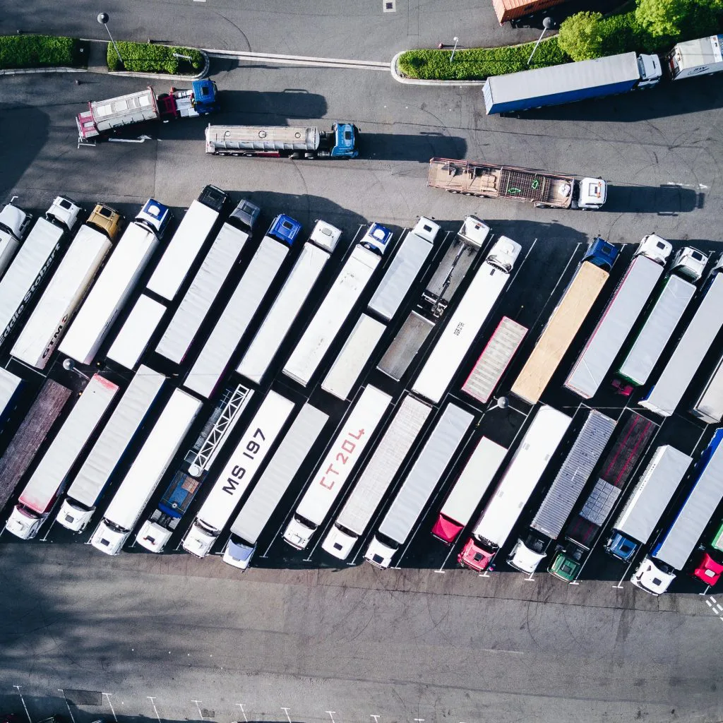 Rows of trucks at a rest stop, clearinghouse services, FMSCA drug testing