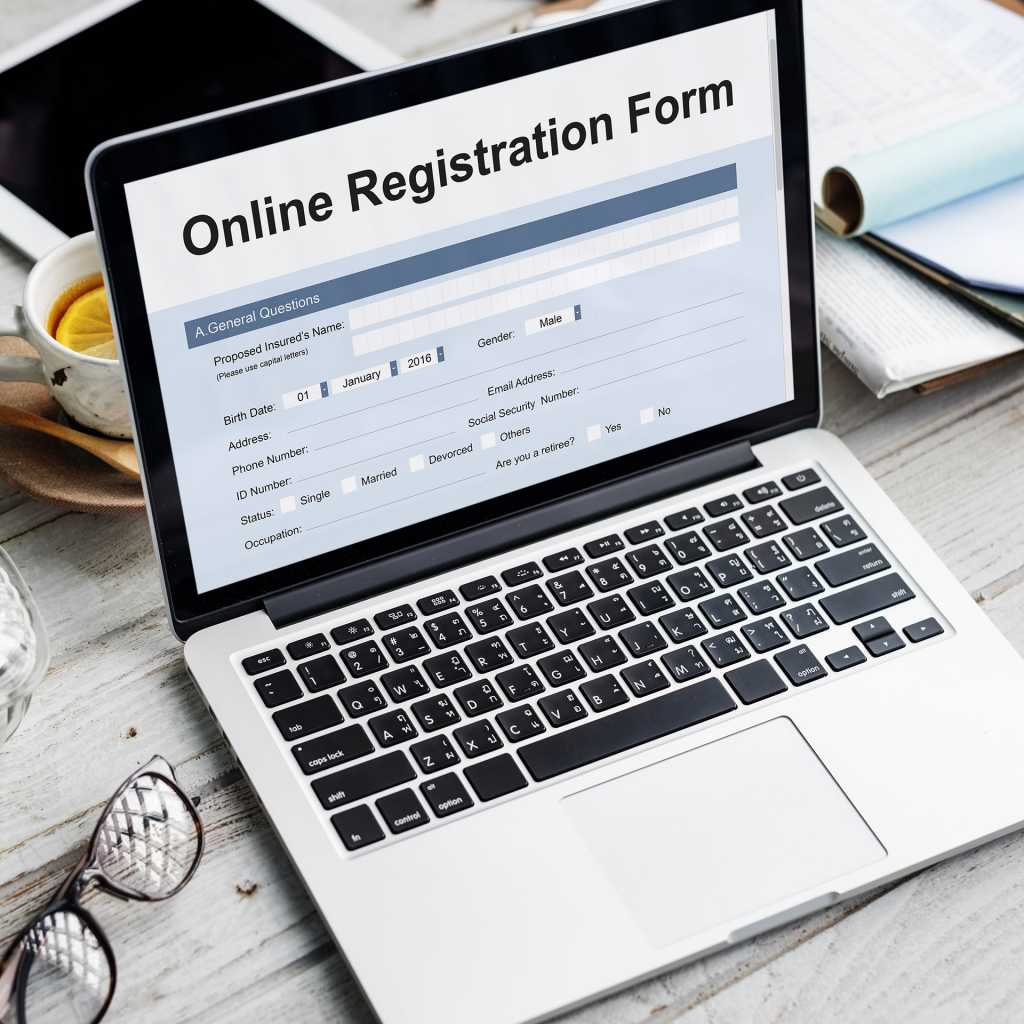 laptop computer with glasses showing online registration form